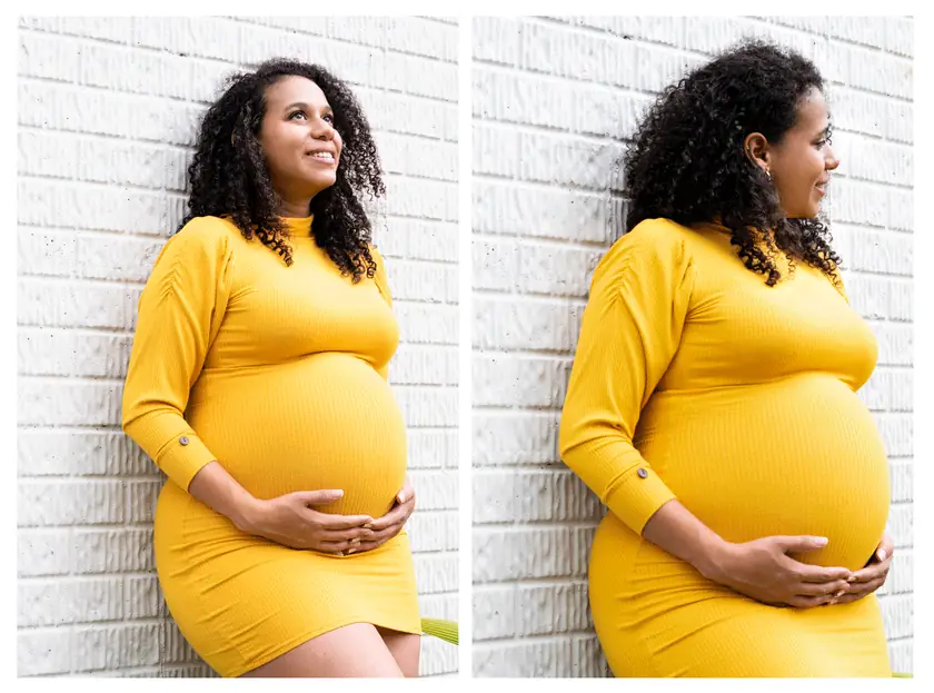 Mujer embarazada con vestido amarillo junto a una pared blanca